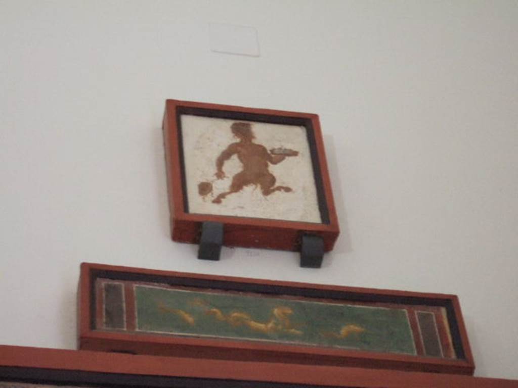 VIII.7.28 Pompeii. 2010. Two paintings from the south end of the east portico.
Upper painting is of Pan with a drum and a plate for offerings.
Now in Naples Archaeological Museum. Inventory number 9128.
Lower painting is of a marine lion with dolphins.
Now in Naples Archaeological Museum. Inventory number 8884.