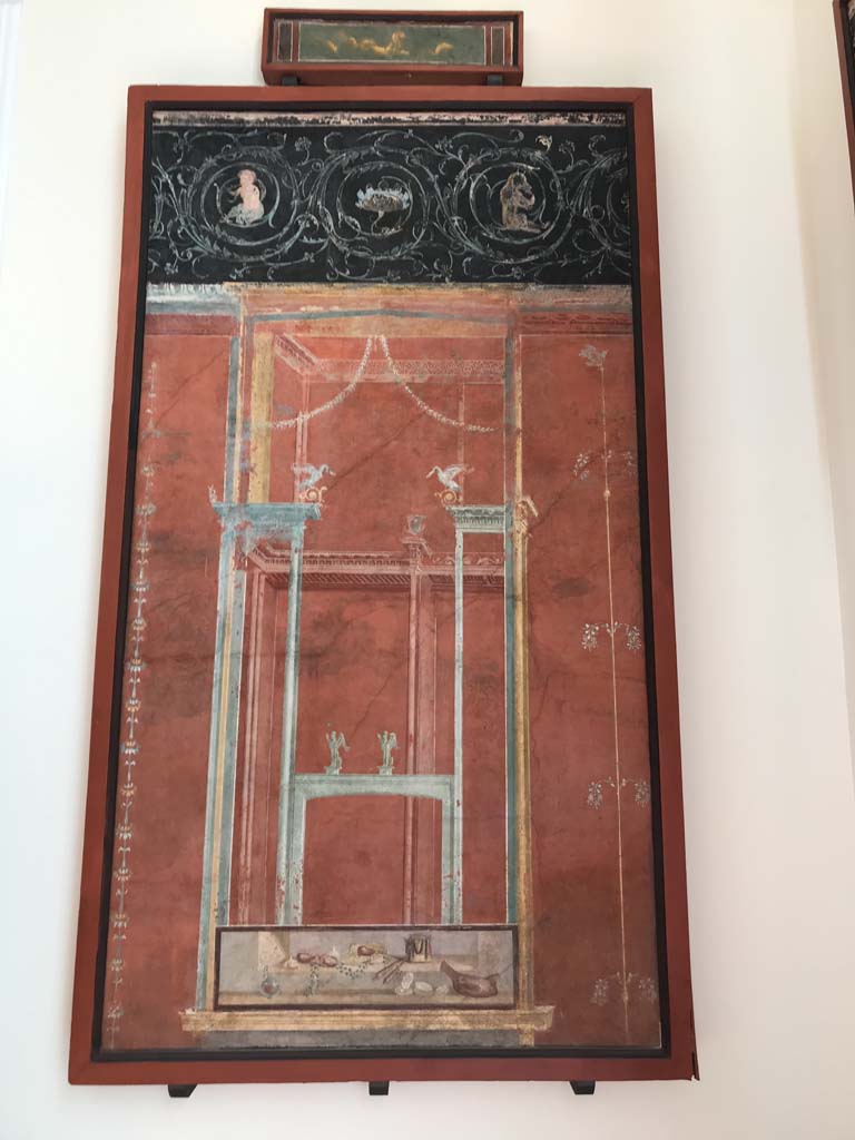 VIII.7.28 Pompeii. April 2019. From north part of the east portico.
Architectural scene with still life and frieze of scrolls.
A similar panel (8536) was found on the opposite western wall.
Now in Naples Archaeological Museum. Inventory number 8537.
Photo courtesy of Rick Bauer.