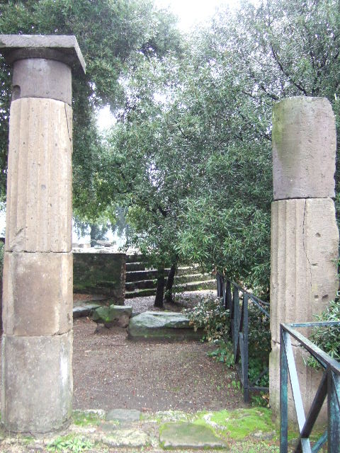 VIII.7.33 Pompeii Triangular Forum. May 2010. Semi circular stone bench or schola with lions’ feet next to the west corner of the temple. Photo courtesy of Rick Bauer.