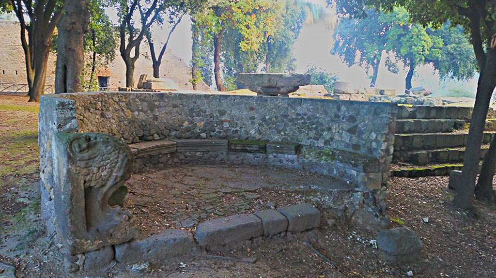 VIII.7.33 Pompeii. 2015/2016.
Semi-circular stone bench or schola with lions’ feet next to the south-west corner of the temple. Photo courtesy of Giuseppe Ciaramella.
