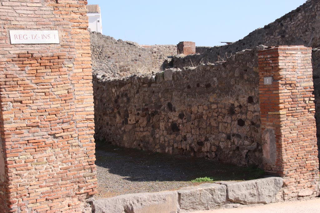 IX.1.1 Pompeii. May 2010 East wall of shop, with doorway to rear room.