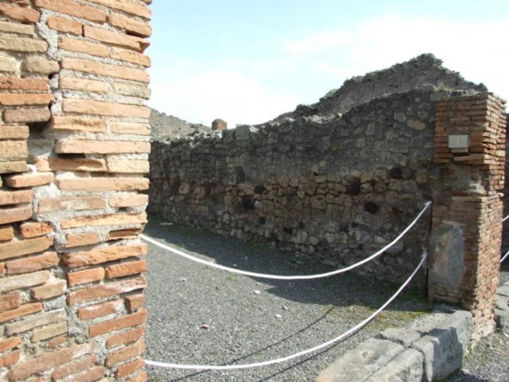 IX.1.1 Pompeii. March 2009. South east corner of shop. The two steps to the rear room show the entrance to the latrine on the left between the steps.