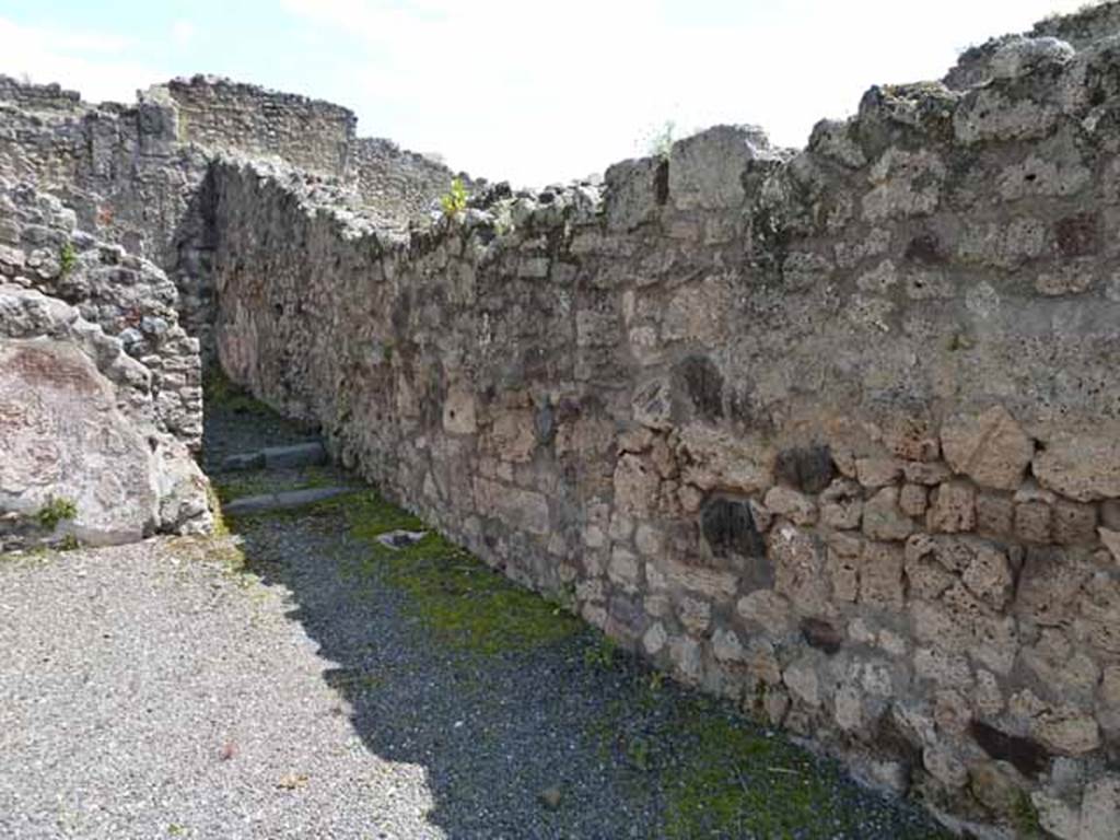 IX.1.1 Pompeii. May 2010. South wall of shop, looking east to rear room.