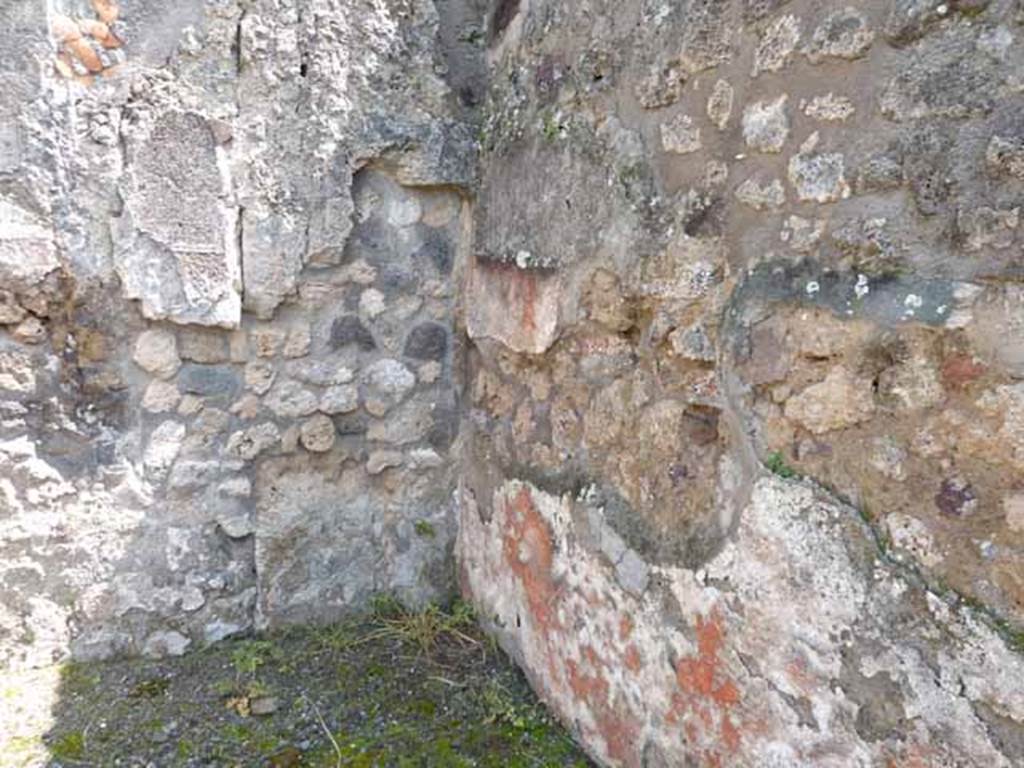 IX.1.1 Pompeii. May 2010. South-east corner of rear room, with remains of painted red zoccolo/plinth.