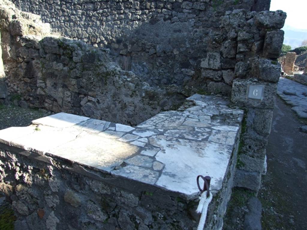 IX.1.6 Pompeii. March 2009. North wall with latrine in north-west corner by drainpipe.