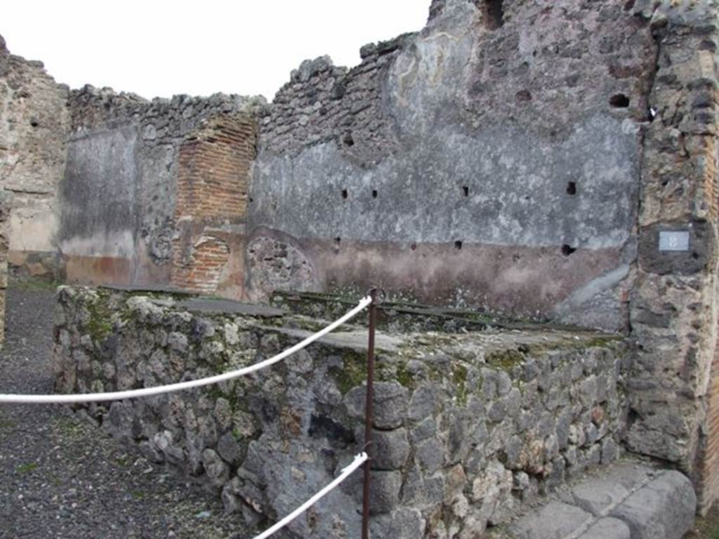 IX.1.8 Pompeii. December 2007. Remains of hearth against north wall.