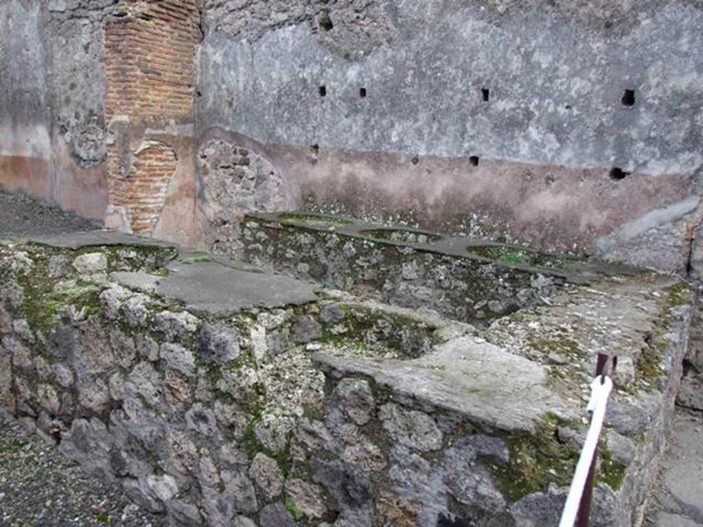 IX.1.8 Pompeii. December 2007. East wall with bricked-up window or recess in rear room.