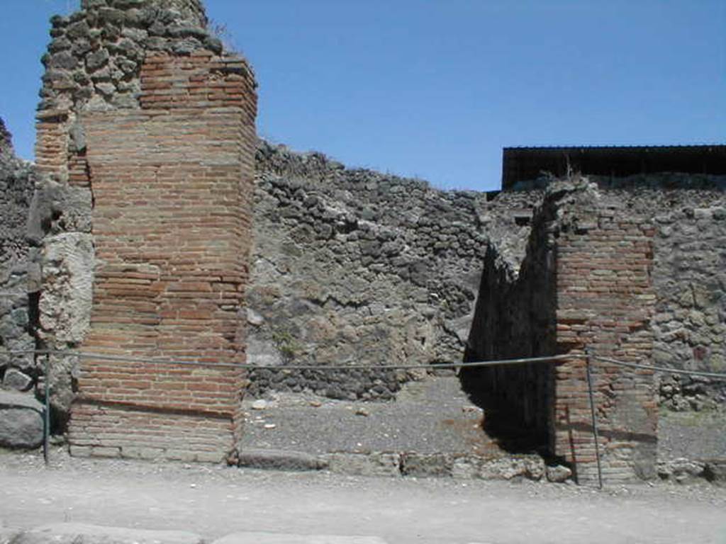 IX.1.9 Pompeii. December 2007. North wall, and north-east corner of shop, with very small remains of base of steps to upper floor.