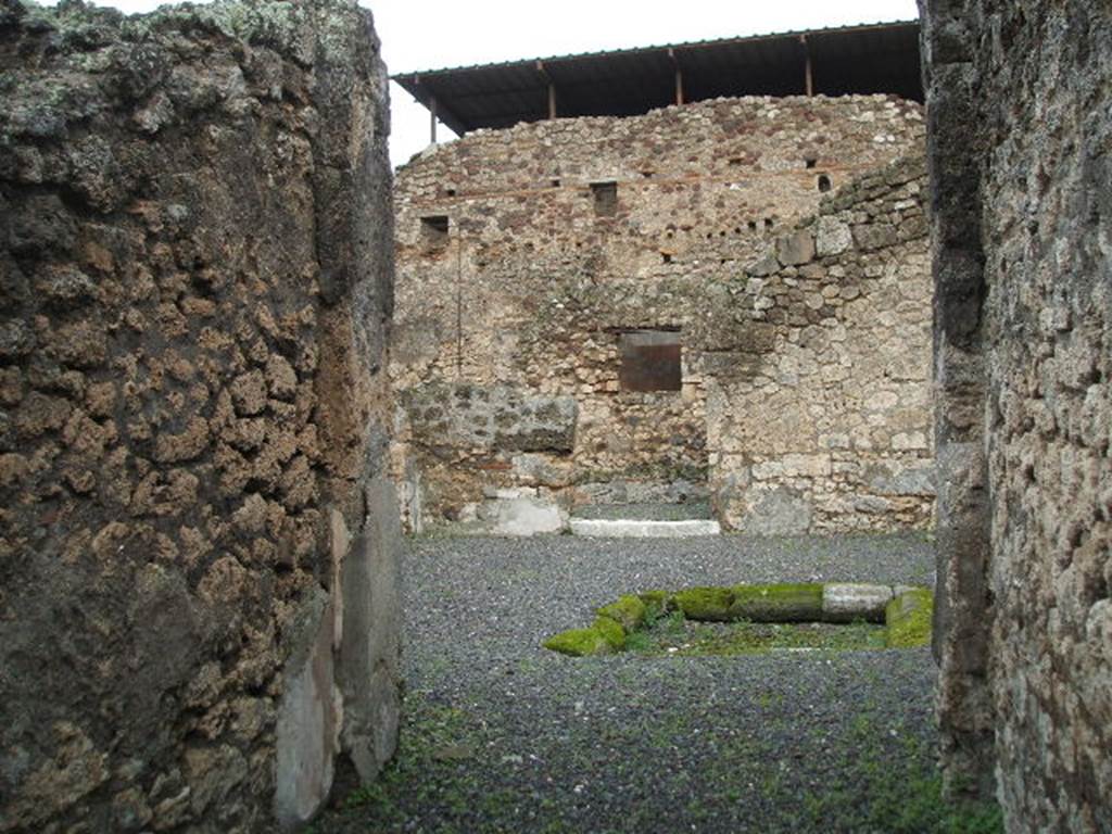 IX.1.12 Pompeii. December 2007. Small doorway in east wall of south east corner of atrium, leading to room with stairs of wood.
