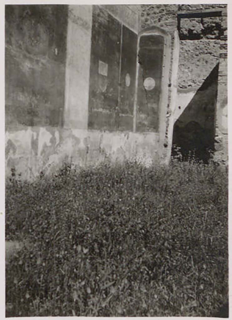 IX.1.22 Pompeii. Pre-1943. Room 1, west wall and north-west corner of atrium. Photo by Tatiana Warscher.
According to Warscher –
“On the west wall, four red panels remained; divided by vertical narrow strips; nearly in the middle there was a wider strip, of around 0.60.
In the centre of the panels rectangles and medallions remained. On the rectangles, attributes of the deities were seen, with landscapes on the medallions. The medallions would have been on the north wall, and at least one remained on part of the wall near to the doorway of the room in the north-west corner of the atrium. Fortunately, the German Institute (DAIR) conserved two copies of watercolours of the landscapes.”
See Warscher, T. Codex Topographicus Pompeianus, IX.1. (1943), Swedish Institute, Rome. (no.111a), p. 195.