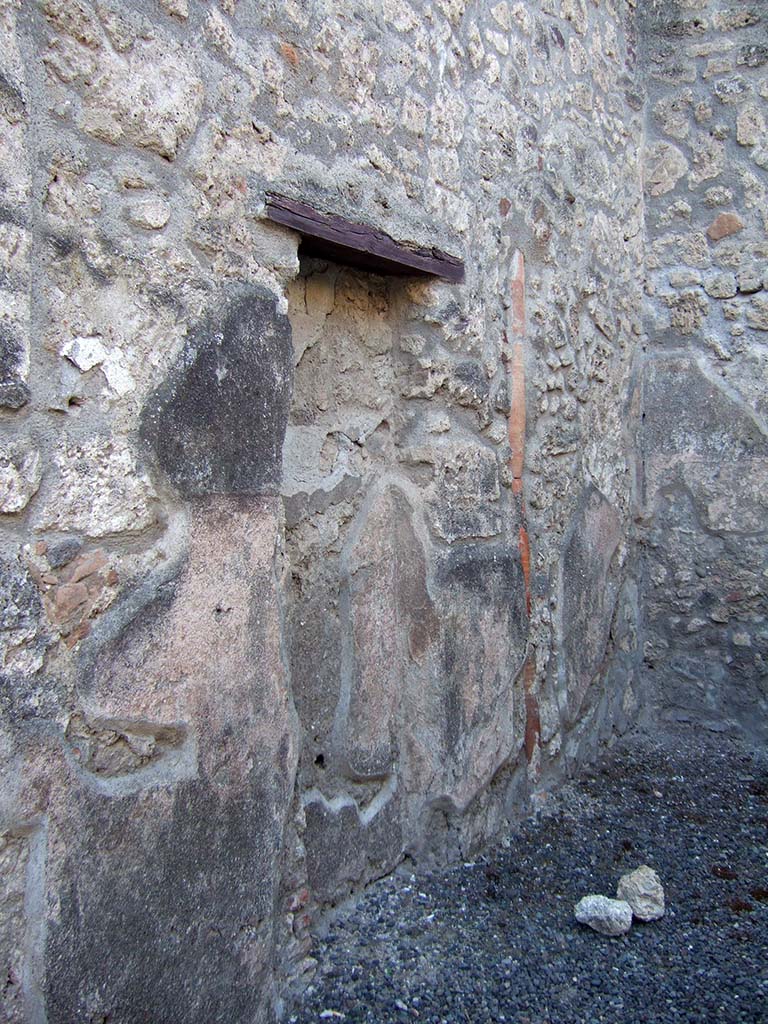 IX.1.23 Pompeii. September 2005. West wall of shop with recess, or blocked door from antiquity, and downpipe.
According to Fiorelli, this shop had belonged to the same house at IX.1.22, so the blocked doorway would have originally led into the entrance corridor of that house.
See Fiorelli, G. (1875). Descrizione di Pompei, (p.376)
See Pappalardo, U., 2001. La Descrizione di Pompei per Giuseppe Fiorelli (1875). Napoli: Massa Editore. (p.140)
According to Hobson, there was a downpipe in the west wall, and that Eschebach had indicated a latrine.
See Hobson, B., 2009. Pompeii, Latrines and Down Pipes. BAR International series 2041. Oxford. Hadrian Books. (p.475).
According to Eschebach, there was a latrine under the steps to the upper floor.
See Eschebach, L., 1993. Geb�udeverzeichnis und Stadtplan der antiken Stadt Pompeji. K�ln: B�hlau. (p.403).
