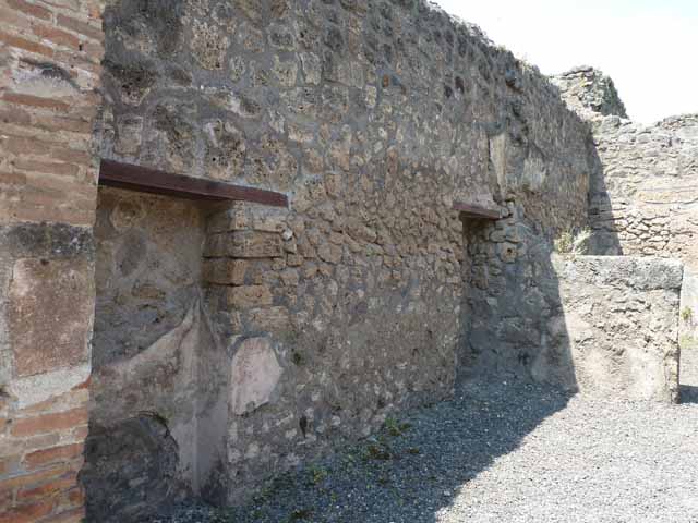 IX.1.24 Pompeii. May 2010. Looking north across shop towards doorway to rear room, and steps to upper floor, on right.