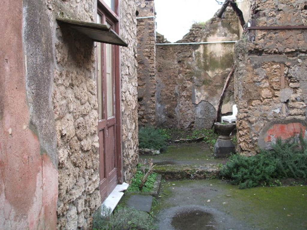 IX.1.26 Pompeii. December 2004. Looking north from entrance corridor across atrium.
On the left would have been a cubiculum and also the triclinium, where the graffito
SODOM(A)  GOMORA  [CIL IV 4976] was found.  
It was inscribed in large letters in charcoal on the wall.
See Cooley, A. and M.G.L., 2004. Pompeii : A Sourcebook. London : Routledge. (p.110)
See Varone, A., 2002. Erotica Pompeiana: Love Inscriptions on the Walls of Pompeii, Rome: L�erma di Bretschneider. (p.141)
See Dobbins, J & Foss, P., 2008. The World of Pompeii. New York: Routledge. (p.195)
According to Mau, the inscription SODOMA
                                                                GOMORA
was found in a triclinium on the left side of the atrium, on the left wall.
See Mau in BdI, 1885, (p.97)
In the centre of the photo is the site of the kitchen and steps to upper floor. According to Boyce, in the kitchen was a lararium painting,but when excavated only the two serpents beside an altar remained.
See Boyce G. K., 1937. Corpus of the Lararia of Pompeii. Rome: MAAR 14. (p.80)
See Pappalardo, U., 2001. La Descrizione di Pompei per Giuseppe Fiorelli (1875). Napoli: Massa Editore. (p.140)
See Sogliano, A., 1879. Le pitture murali campane scoverte negli anni 1867-79. Napoli: (p.18, no.52)
