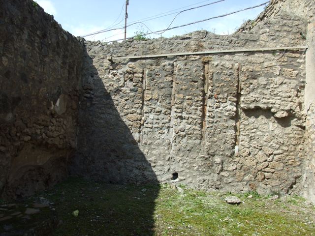 IX.1.27 Pompeii. March 2009. West wall, with remains of recess, which would have been under the stairs.