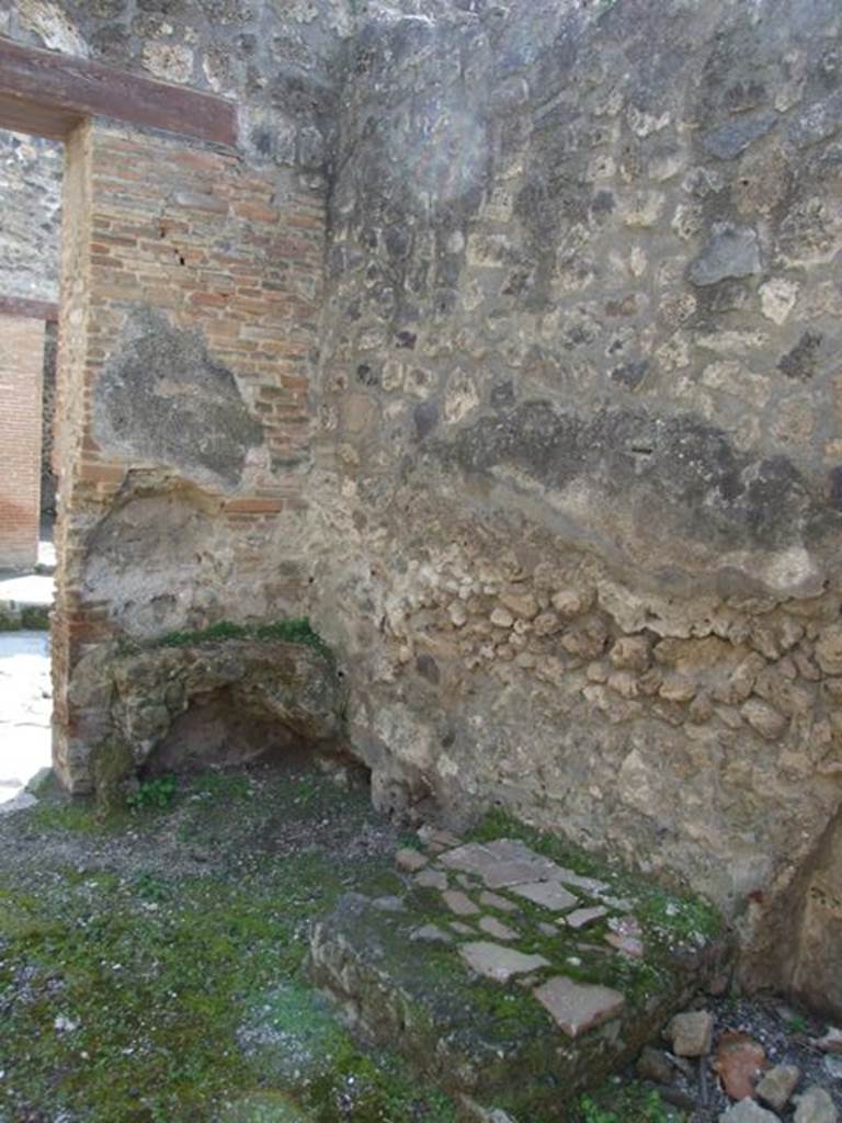 IX.1.27 Pompeii. March 2009.  South-west corner at front of shop, with remains of hearth. On the left of the entrance, was the hearth and an altar. According to Boyce, it was �a kind of altar with a small niche in the wall above it � presumably for the cult of the Lares�. Apparently fixed to it there was a marble slab bearing the inscription
PACVVIVS . ERASISTRATVS . EX . VIsv   [CIL X 930]
Boyce also noted that Fiorelli said nothing about the connection between the altar and the incised slab but noted that the slab had been re-used as materiale di costruzione.
See Boyce G. K., 1937. Corpus of the Lararia of Pompeii. Rome: MAAR 14. (p.80) 
See Pappalardo, U., 2001. La Descrizione di Pompei per Giuseppe Fiorelli (1875). Napoli: Massa Editore. (p.140)
Cooley translates the latin inscription to
Pacuvius Erasistratus, after a vision.    [CIL X 930]
See Cooley, A. and M.G.L., 2004. Pompeii : A Sourcebook. London : Routledge. (p.106, E58), where it is said to have come from IX.1.25.
According to Boyce above, the place of discovery of CIL X 930, was given as IX.1.25, but wrongly so; cf. Fiorelli and the Bull.Inst.
He gives the references - Fiorelli, Descr., 376; Bull. Inst., 1867, 162.
