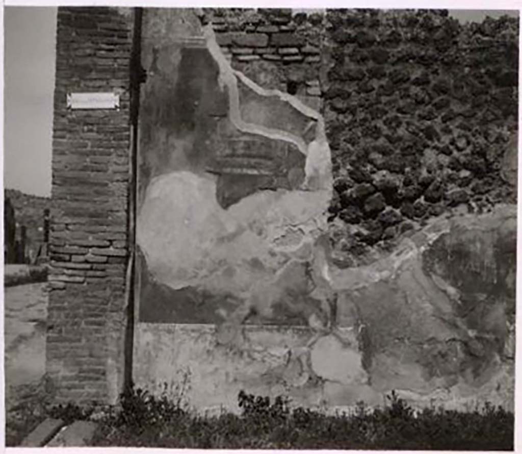 IX.2.7 Pompeii. Pre-1943.
Looking towards north wall of shop with faded wall decoration. Photo by Tatiana Warscher.
See Warscher, T. Codex Topographicus Pompeianus, IX.2. (1943), Swedish Institute, Rome. (no.17.), p. 42.
According to Minervini -
“The floor of the shop was made from crushed black lapilli. The walls were painted with several compartments of red, of yellow and of black with various friezes; in the lower part was a black zoccolo with decorations of green plants. On the two side walls were two preserved paintings, and two nearly entirely faded: in one to the left was a swan, in the other to the right was a bird, preparing to peck at some fruit. In the same wall was a small lararium. A white wall continued above the described compartments, with bands of different colors, and with suspended branches. In one of the paintings formed by those bands a vase was seen, and nearby a small thysus; in another a swan, and various decorations, including two candelabras with globes above. Higher up appeared traces of another wall, with paintings of foliage; but not observing traces of support beams, it was very likely that this was an all-wooden construction, which formed a mezzanine, to which one ascended on a wooden ladder.”
See Bullettino Archeologico Napoletano Nuova Serie: Anno Primo, no.4, Agosto 1852, p.25. Minervini.