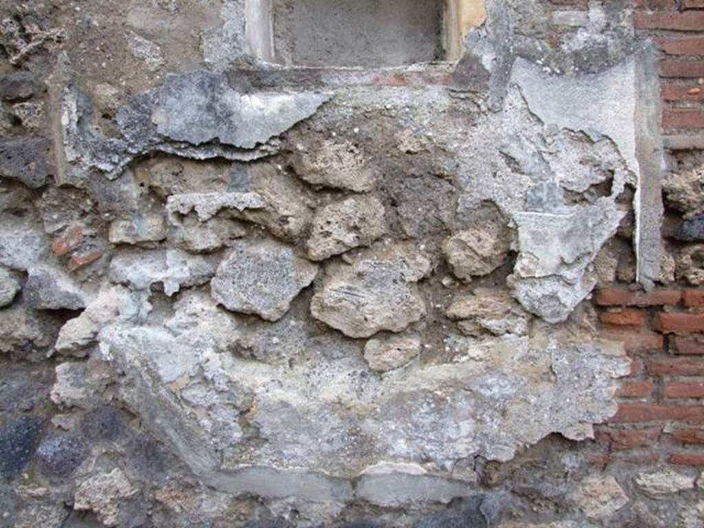 IX.2.24 Pompeii. March 2009. West wall under niche. Lower part of Lararium painting.  One very small part of a serpent is all that can still be seen. 
See Fr�hlich, T., 1991, Lararien und Fassadenbilder in den Vesuvst�dten.  Mainz: von Zabern.  (L99: p.293, T. 42, 3). 
According to Boyce, in the lower zone a large serpent advanced from the right towards an altar furnished with offerings. Across the top of the whole painting was stretched a garland.
See Boyce G. K., 1937. Corpus of the Lararia of Pompeii. Rome: MAAR 14. (p. 82, no. 403 and Pl. 24, 2.) 
