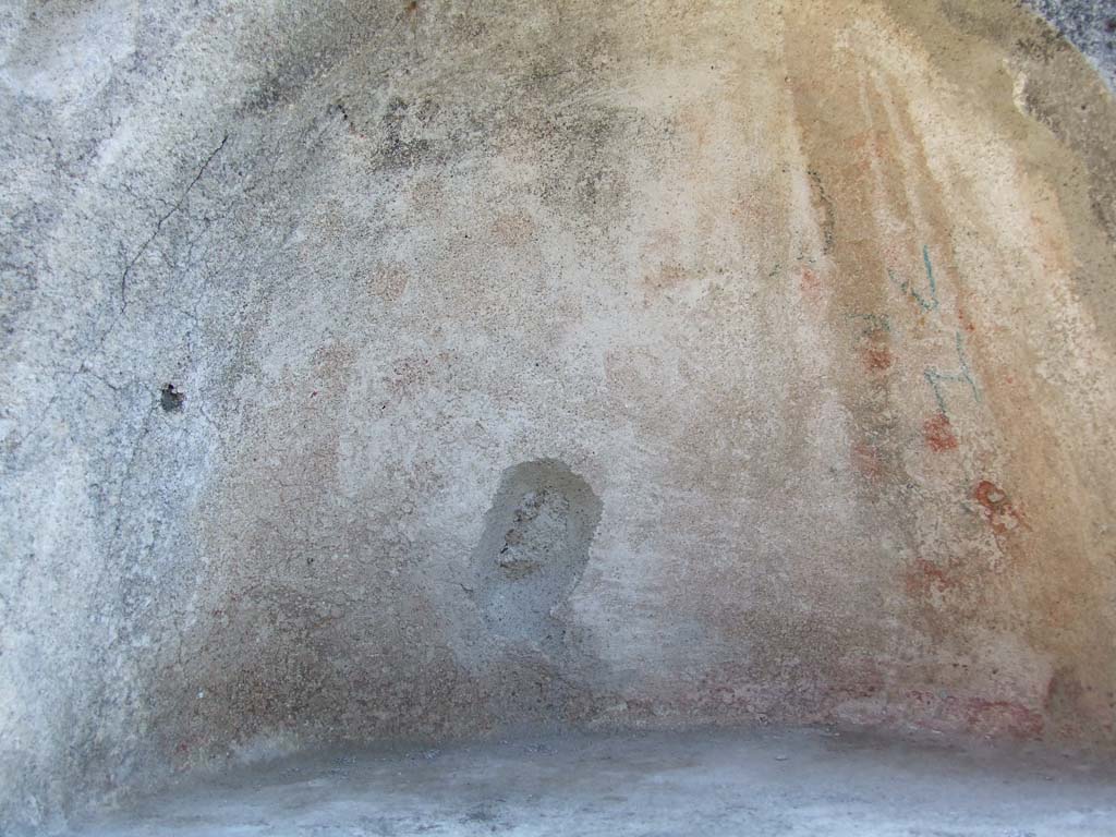 IX.3.2 Pompeii. March 2009. Garden area. Niche in south wall. The niche was originally decorated with yellow, red and green flowers.
See Giacobello, F., 2008. Larari Pompeiani: Iconografia e culto dei Lari in ambito domestico. Milano: LED Edizioni. (p.284).
According to Boyce, the inside walls were decorated on a white background with red and yellow spots and outlined with red stripes.
The two Lares were painted on the wall above the niche and below it the serpents, confronted at an altar.
Bronze statues were found in the niche on12th July 1847: a female figure, a male figure, Hercules, Jupiter, and Isis-Fortuna.
See Boyce G. K., 1937. Corpus of the Lararia of Pompeii. Rome: MAAR 14. (p. 82, Pl. 4, 2.) 
Helbig also gave a description of the statuettes found in the niche:
See Helbig, W., 1868. Wandgemälde der vom Vesuv verschütteten Städte Campaniens. Leipzig: Breitkopf und Härtel. (69b)
