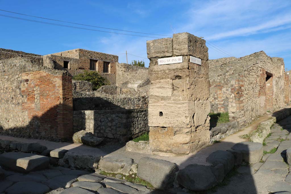IX.3.10, centre left, and IX.3.11, centre right, Pompeii. December 2018.
Looking north-east towards corner of junction between Via Stabiana, on left, and Vicolo, on right. Photo courtesy of Aude Durand.