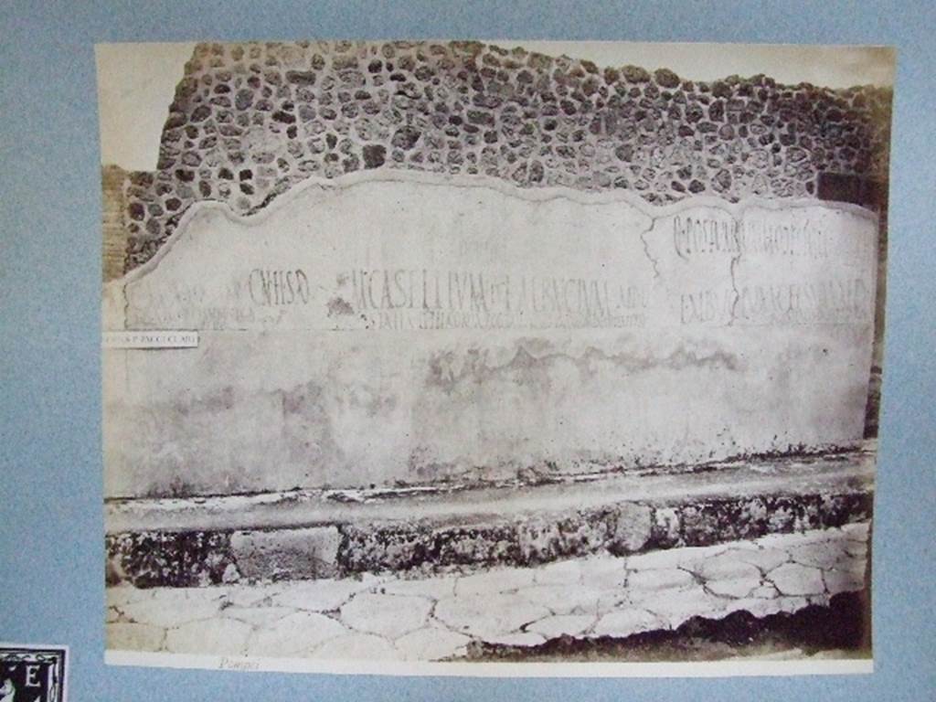 IX.3.19 Taberna T. Genialis. Graffiti on wall between IX.3.18 and IX.3.19. Old undated photograph courtesy of the Society of Antiquaries, Fox Collection.