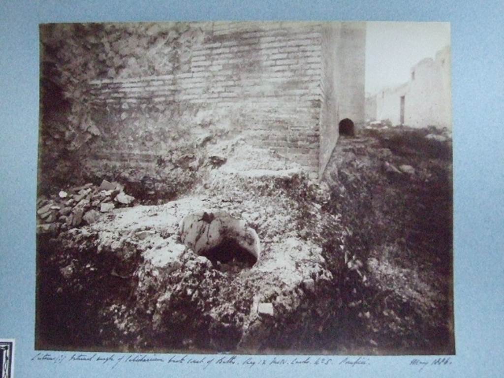 IX.4.15 Pompeii. May 1886. Cistern (?) at external angle of caldarium, back court of Baths.�. 
Courtesy of Society of Antiquaries. Fox Collection.
This photograph is looking north along the east wall of calidarium �s� along baths area �t�.
The small arch in the base of the projecting tepidarium �q� wall can be seen.
The open area �u� and the doorway at IX.4.16 can be seen in the wall on the right.
