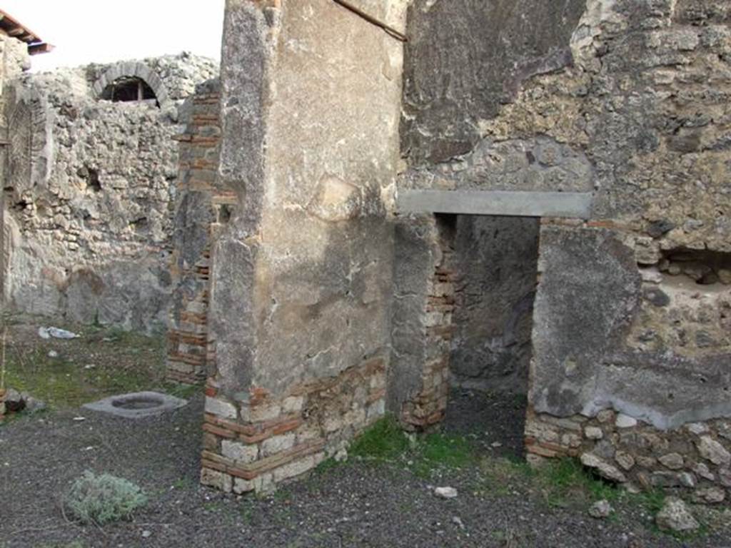 IX.5.2 Pompeii. December 2007. Room �v�, large exedra. 
Looking north-east to peristyle �p� (on left) and small door in east wall of corner of room �v� into corridor leading to rooms �x� and �y�.

