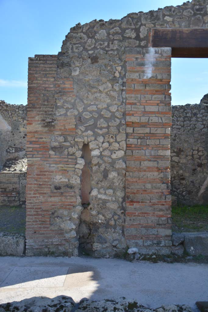 IX.5.8, on left, and IX.5.7, on right, Pompeii. March 2017. 
Looking south to pilaster between two entrance doorways, with terracotta downpipe. 
Foto Christian Beck, ERC Grant 681269 D�COR.
