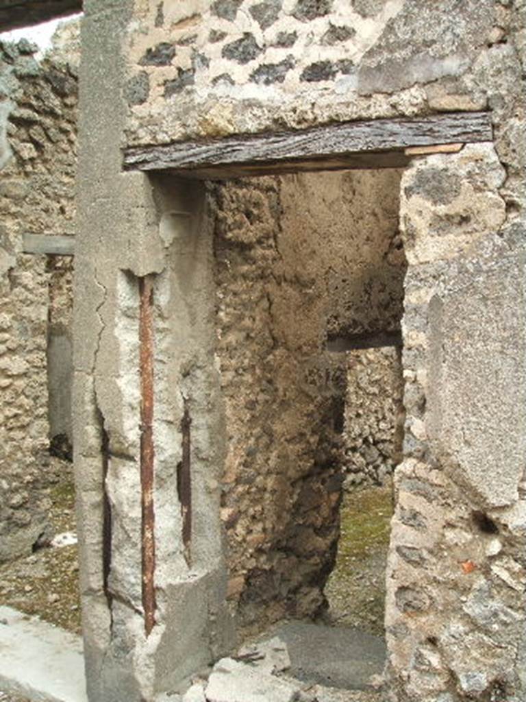 IX.5.18 Pompeii. May 2005. Room v, room under steps to upper floor, with door to corridor in north wall.