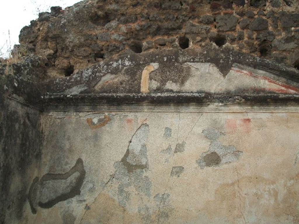 IX.5.18 Pompeii. May 2005. Room “p”, looking towards upper west wall of cubiculum with two doors.
The west wall was vaulted and had a moulded cornice.
The red zoccolo was panelled, the panels of the white middle zone were separated by narrow compartments with a red background crossed by smooth candelabra towards the base and summit and twisting in the central part.
