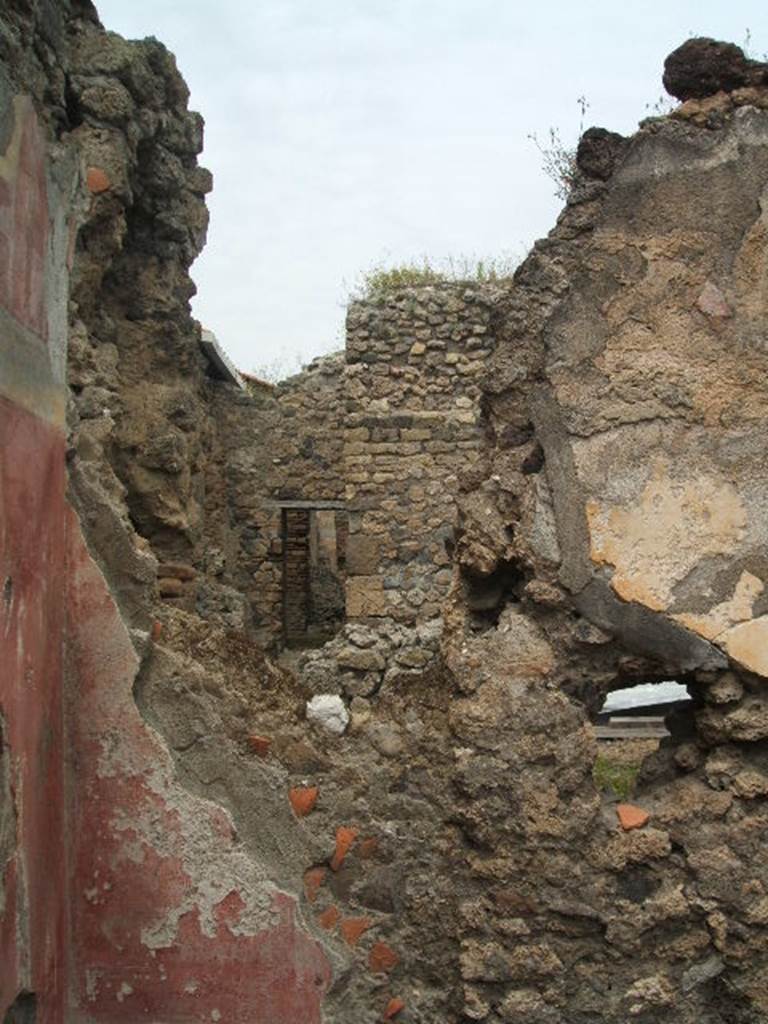 IX.5.18 Pompeii. May 2005.
Room p, north-west corner, looking through wall towards IX.5.4, from IX.5.18.