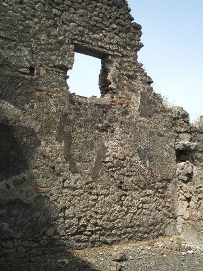 IX.6.3 Pompeii. May 2005. West wall of triclinium “a” to north of entrance.
This room had a window overlooking Vicolo di Tesmo.
According to Mau, this room had a wooden threshold and a floor ornamented with irregular pieces of marble.
None of the wall decoration was preserved other than the rough plaster that was destined to be covered again with a finer layer.
This room may have been used to store various objects, as on 10th July 1879 various bronze and terracotta vases were found, together with the fragments of a saw, some bronze coins, etc.
See Notizie degli Scavi di Antichità, 1879, p. 207.
See Mau in BdI, 1880, p. 217.