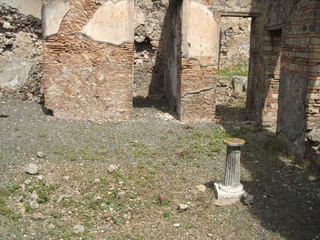 IX.6.3 Pompeii. May 2005. Looking south along small garden area to large triclinium, on south side. According to Jashemski, this small open area at the rear of this small house was visible from the entrance through a window at the rear of the atrium (on right of photo between the doorways). Attached to the wall on the east side were 3 steps which in the middle had a small basin the height of the lowest 2 steps. The passageways around the open area were roofed by the overhang of the adjacent rooms. See Jashemski, W. F., 1993. The Gardens of Pompeii, Volume II: Appendices. New York: Caratzas. (p.238)