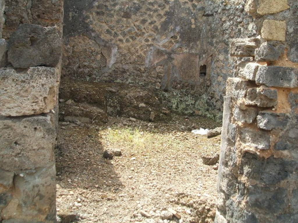 IX.6.3 Pompeii. May 2005. Doorway to kitchen area, looking south.
According to Boyce, on the east wall (not photographed) was a lararium painting, the upper part was damaged when found. An altar stood between the Genius on the right, and the tibicen on the left. On each side was a Lar with rhyton and situla standing between two shrubs. In the lower zone were two serpents confronted at an altar furnished with two eggs. See Boyce G. K., 1937. Corpus of the Lararia of Pompeii. Rome: MAAR 14. (p.86, no.428). See Sogliano, A., 1879. Le pitture murali campane scoverte negli anni 1867-79. Napoli: (p.12, no. 25) According to Giacobello, today the painting has been totally lost.
See Giacobello, F., 2008. Larari Pompeiani: Iconografia e culto dei Lari in ambito domestico. Milano: LED Edizioni. (p.209)