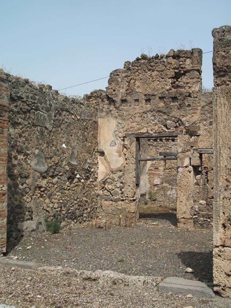 IX.6.e Pompeii. May 2005. Niche on east wall. According to Boyce, in the east wall of the taberna was a niche with peaked ceiling. Its walls were coated with white stucco outlined in red. Around it on the wall was a lararium painting, of which only a cornucopia on the left side could be seen when excavated.  See Boyce G. K., 1937. Corpus of the Lararia of Pompeii. Rome: MAAR 14. (p.87, no.433) .  According to Sogliano, in the shop a sacred picture was found. Notizie d.Sc.d.Ant, 1879, p.72. See Sogliano, A., 1879. Le pitture murali campane scoverte negli anni 1867-79. Napoli: (p.19, no.71)
