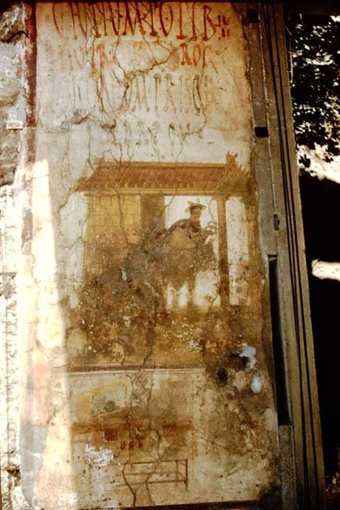 IX.7.7 Pompeii. 1959. Painting of Mercury, and inscriptions, originally found on the west side of the entrance doorway on Via dell’Abbondanza. Photo by Stanley A. Jashemski.
Source: The Wilhelmina and Stanley A. Jashemski archive in the University of Maryland Library, Special Collections (See collection page) and made available under the Creative Commons Attribution-Non Commercial License v.4. See Licence and use details.
J59f0155