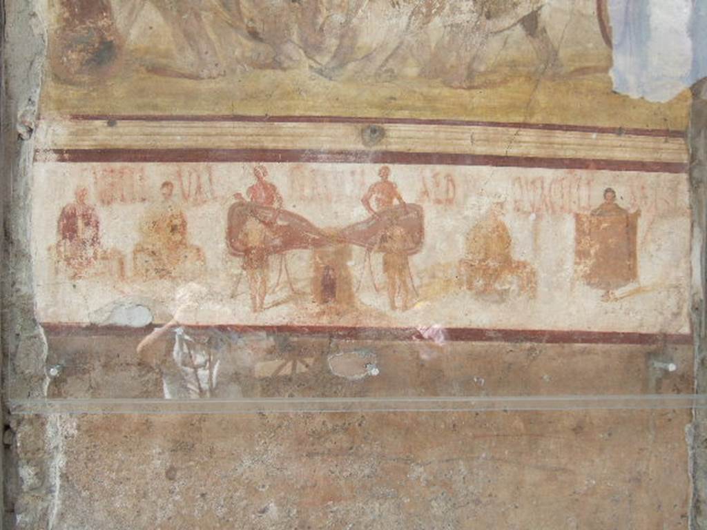 Between IX.7.7 and IX.7.6 Pompeii. May 2006, lower part of painting of Venus, depicting felt workers (coactiliarii) producing cloth.