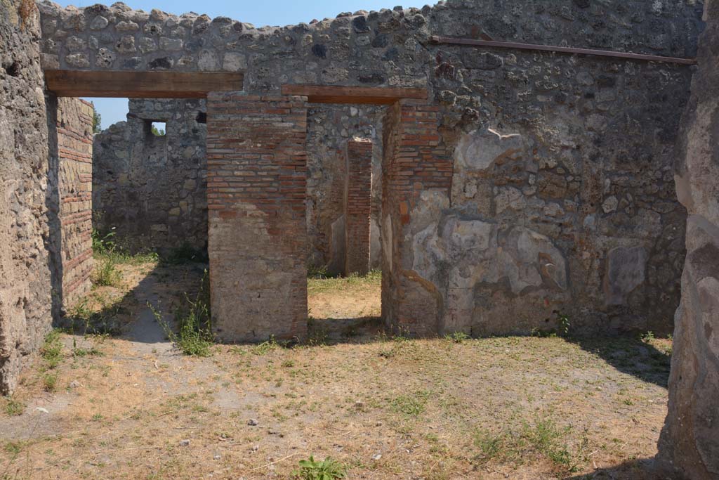 IX.7.19 Pompeii. July 2017.
Looking south across atrium towards two doorways, the one on the right leading into room e, at the rear of room d, which is the shop at IX.7.18.
Foto Annette Haug, ERC Grant 681269 DÉCOR.
The other doorway on the left, the rear right of the atrium, leading to room f, a corridor leading to the rear of the house including kitchen and garden.
According to Mau, a pile of material at the entrance of the corridor f, could have been the first step of a stairway to the upper rooms.
Room i was the kitchen with the latrine.
The entrance doorway was very narrow and cut obliquely across the wall in the corner.
Near the south wall was the hearth, and the latrine.
Near the north wall was a large pilaster (1.15 x 1.07) composed of opera incerta (lava) and limestone cut into the form of bricks.
This pilaster was joined with the east wall for an arch, on which was a narrow platform between the pilaster and the east and north walls.
According to Boyce, a small room, room k, located between kitchen and garden on the south side of the house, was originally part of the garden.
This small room had a doorway into the kitchen.
Then the room was separated from the garden and the doorway to the kitchen was bricked-up.
On the east wall of this new room was a lararium, with a Genius standing to the right of a tripod.
On the other side of the tripod stood the tibicen. Below and to the right, ran a camillus.
Below this were two serpents, gliding, one from each side, amongst plants towards an altar.
Between this painting and the south-east corner of the room were painted, two pots, a large bottle, sausages, a calf’s head, ribs of pork on a spit, and a phallus.
See Boyce G. K., 1937. Corpus of the Lararia of Pompeii. Rome: MAAR 14. (p.88, no.438)
See Giacobello, F., 2008. Larari Pompeiani: Iconografia e culto dei Lari in ambito domestico. Milano: LED Edizioni, (p.209, no.106)
The following items were found on 28th December 1880, in “ultima camera interna a destra dell’atriolo” – the last internal room on the right from the atrium. (This would be the room k with the lararium painting).
The remains of a small wooden box with bronze lock and decorations, was found together with the following items gathered together –
A bronze lamp (a lantern to a lamp with two handles made to look like branches surmounted by a shield – Naples Archaeological Museum, inventory number: 118253
A terracotta cup with two handles - Naples Archaeological Museum, inventory number: 113025
A terracotta lamp with separate handle - Naples Archaeological Museum, inventory numbers: 117227, 117228
A glass bottle - Naples Archaeological Museum, inventory number: 114908
Also found were various bronze, terracotta, bone, iron and marble items, as well as 42 containers with various colours.
See Mau in Bullettino dell’Instituto di Corrispondenza Archeologica (DAIR), 1883, (p. 82-3).
See Sogliano in Notizie degli Scavi di Antichità, 1880, (p. 491 and p. 493-4).
Thanks to Raffaele Prisciandaro for his assistance in locating the inventory numbers of the items in the Naples Archaeological Museum.
According to Notizie degli Scavi di Antichità, 1881, p.63, the following objects were found in the presence of scholars of the r. Istituto di belle arti di Napoli on 17th February 1881.
They were found in one of the internal rooms.
Bronze basin with damage in the middle, and two unsoldered handles that finished with the head of a sea-horse - Naples Archaeological Museum, inventory number 118197
Bronze tweezers or small pliers.
Two bronze hinges.
A small bronze coin.