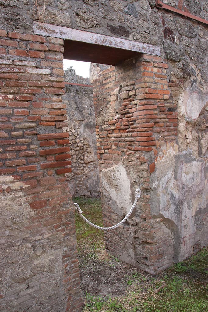 IX.7.19 Pompeii. October 2024.
Doorway into room e, in east wall of atrium b, leading into rear room of IX.7.18.
Photo courtesy of Klaus Heese.
