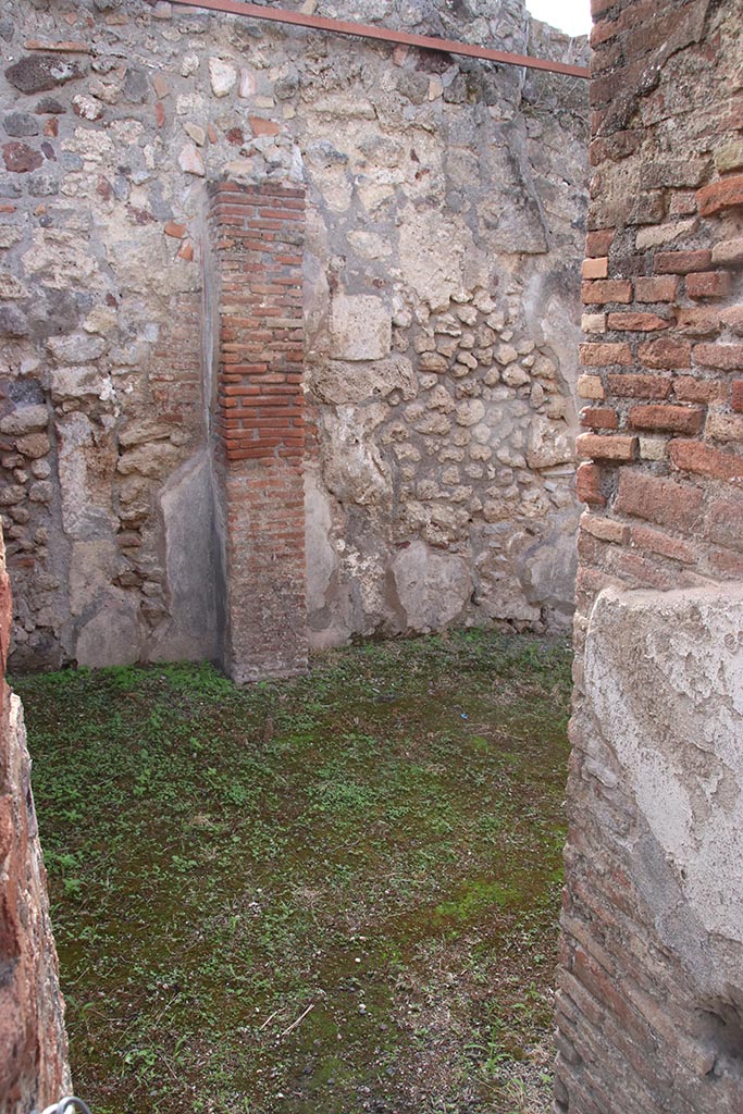 IX.7.19 Pompeii. October 2024.
Room e, looking south-west through doorway towards south wall of rear room of IX.7.18.
Photo courtesy of Klaus Heese.