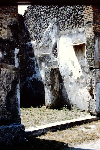IX.8.2 Pompeii. May 2010. East wall of front and rear rooms.
According to Garcia y Garcia, a painting of a sacred landscape would have been seen in the centre of the east wall. This was soon lost and is no longer visible.  Two drawings of the painting can be found in the German Archaeological Institute of Rome.  See Garcia y Garcia, L., 2005. Pupils, Teachers and Schools in Pompeii. Roma: Bardi editore. (p. 72-3, with figs 41-42 showing two drawings of the sacred landscape).
See De Carolis, E. 1989. Italienische Reise. Naples: Bibliopolis, (p. 250 & fig. 93 on page 323) There was a frieze on a black background on the upper walls.  A small trace survived on the east wall, depicting figures of philosophers. Five drawings of these can be seen in Fig.120, of Schefold, but it says they were found at the shop at IX.8.4.
See Schefold, K., 1962. Vergessenes Pompeji. Bern: Francke. (Fig.120)


