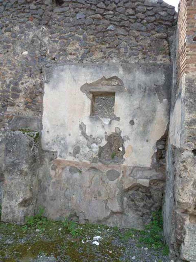 IX.8.2 Pompeii. May 2010. West wall of front room of shop, with window now to IX.8.1, in centre. According to Garcia y Garcia the painting of a sacred landscape, in the middle of the central panel on the west wall is still partially discernible. Perhaps this painting has been removed from the wall for safe-keeping and a window inserted.
See Garcia y Garcia, L., 2005. Pupils, Teachers and Schools in Pompeii. Roma: Bardi editore. (p. 74-5, with figs 43-45 showing three versions of the sacred landscape, now in the German Archaeological Institute of Rome).See De Carolis, E. 1989. Italienische Reise. Naples: Bibliopolis, (p.250 & fig. 92 on page 323)