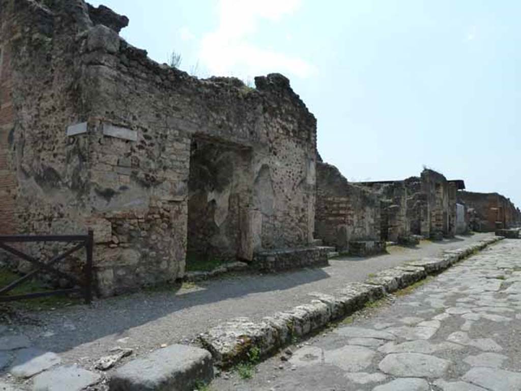 IX.8.7 Pompeii. May 2010. Entrance on south side of Via di Nola, looking west. 
On the west (right) side of the entrance doorway, between IX.8.7 and 6, (centre of photo) were found �
(A.) Rustius (Verus) (rogat)  [CIL IV 3750]
(A.) Rustius (Verus) facit      [CIL IV 3751]
And a third written at the side of number 3 read - (A.) Rustius (Verus) facit     [CIL IV 3738 with Note 4]
See Della Corte, M., 1965.  Case ed Abitanti di Pompei. Napoli: Fausto Fiorentino. (p.133)  
According to Epigraphik-Datenbank Clauss/Slaby (See www.manfredclauss.de), these read as �
M(arcum) Licinium Faus 
/tinu[m]
aed(ilem) v(iis) a(edibus) s(acris) p(ublicis) p(rocurandis) v(irum) b(onum) d(ignum) r(ei) [p(ublicae) o(ro)] v(os) f(aciatis) Rustius rog(at)    [CIL IV 3750]

C(aium) Calventium Sittium
/IIv(i)r(um)
Rustius facit OMLVS idem facit      [CIL IV 3751]

L(ucium) Popidium Secundum
aed(ilem) o(ro) v(os) f(aciatis) Fustius faci ,<t=I> scrib[it      [CIL IV 3738]

Also found were the following recommendations from the neighbours. 
Ti. Claudium Verum, II virum   
vicini rogant         [CIL IV 367]

Ti. Claudium Verum  
vicini rog(ant)      [CIL IV 440]

They prove the nearness of the house of this magistrate, but cannot identify it precisely.  Mau thought it was definitely the House of the Centenario because of the graffiti found on the middle column on the south side of the peristyle.
This named - Ti(berius) Claudius Ver(us)      [CIL IV 5229]

Also found on the fa�ade, between the entrances of numbers IX.8.7 and 6, was the electoral programme -
Rustium Verum d.i.d
(Ti. Claudi) Vere, fac qui te fecit      [CIL IV 3760 with Note 2]
See Della Corte, M., 1965.  Case ed Abitanti di Pompei. Napoli: Fausto Fiorentino. (p.131)  
According to Epigraphik-Datenbank Clauss/Slaby (See www.manfredclauss.de), this read as �
Rustium Verum d(uumvirum) i(ure) d(icundo) 
/ vere
fac qui te fe[cit]       [CIL IV 3760]
