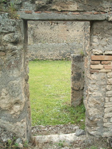 IX.9.10 Pompeii. March 2009. Sacellum, or former kitchen. Looking east. Room with three niches and an altar with a masonry bench along the north wall and the north east corner. See Boyce G. K., 1937. Corpus of the Lararia of Pompeii. Rome: MAAR 14. (459, PL 41,1)