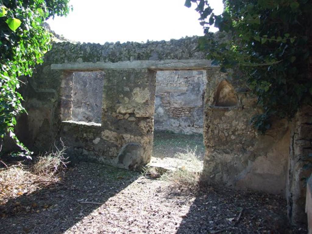IX.9.11 Pompeii. March 2009. Niche on west wall of atrium, with doorway and window to Room 6, Garden.