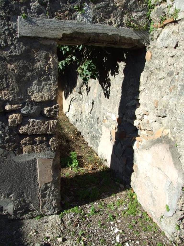 IX.9.11 Pompeii. March 2009. Doorway to Room 7, large Triclinium on north side of garden area.