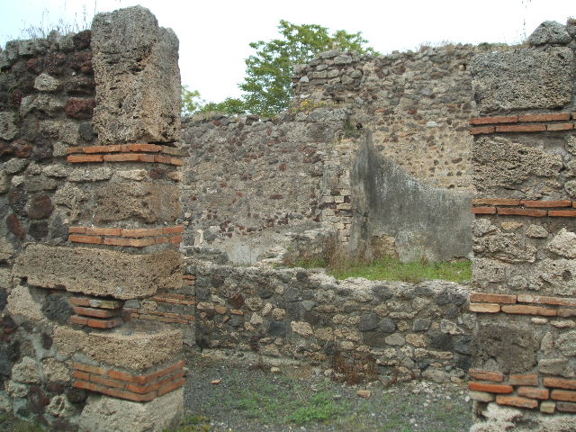 IX.9.a Pompeii.  March 2009.  Looking south along wide passageway to Kitchen and Latrine in south west corner.