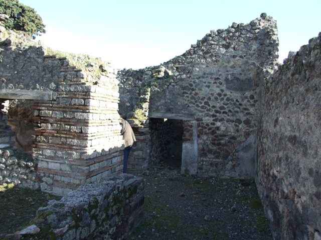 IX.9.a Pompeii.  March 2009. North-west corner of kitchen, looking west across latrine.