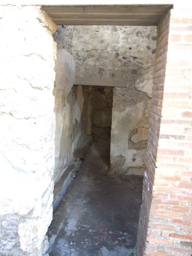 IX.9.c Pompeii. March 2009. Anteroom with drain on south side which emptied into the street. According to NdS, this room had flooring of signinum, and walls painted with a yellow background, although the frieze was painted to look like imitation marble. In this room two bronze seals were found –
on 12th April 1887, with the wording - Q. Nolani \ Primi (see Notizie degli Scavi, 1887. p. 245), and
on 21st June 1887, with the wording - C. Salpici \ Rufi (see Notizie degli Scavi, 1887, cit. p. 379).
See Notizie degli Scavi, 1889, p.129
