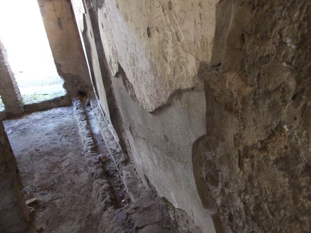IX.9.c Pompeii. March 2009. Looking east along south wall of small room and anteroom, with drain.