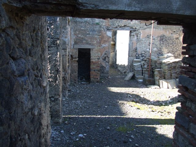 IX.9.d Pompeii. March 2009. Room 9, remains of painted plaster near south-west corner of hearth in kitchen.